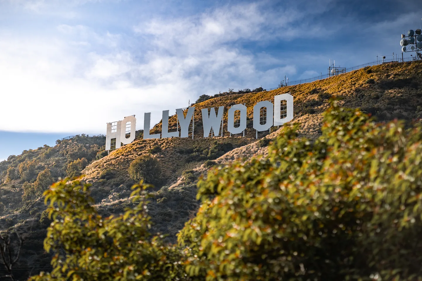 The Hollywood Sign across a sunlit hillside in Los Angeles